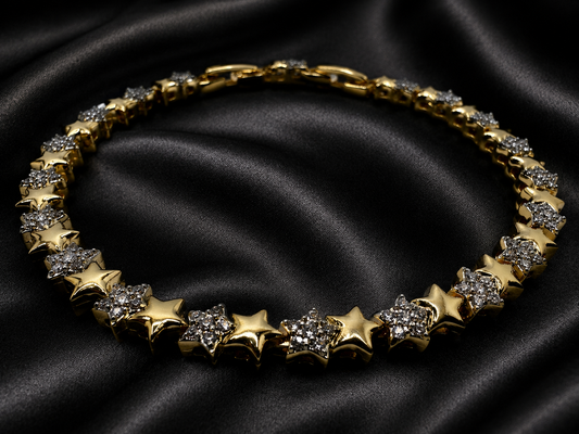 Gold necklace with star-shaped pendants on a black satin background