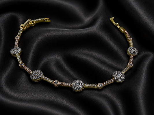 Gold bracelet with diamond accents on black satin fabric