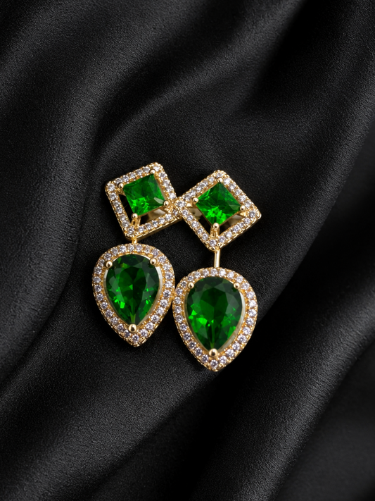 Green gemstone earrings on a black satin background