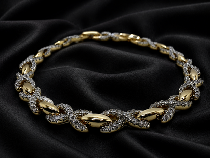 Gold necklace with diamond accents on a black fabric background