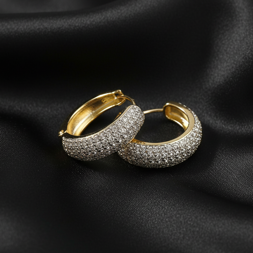 Pair of gold and silver hoop earrings on a white background