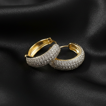 Pair of gold and silver hoop earrings on a white background