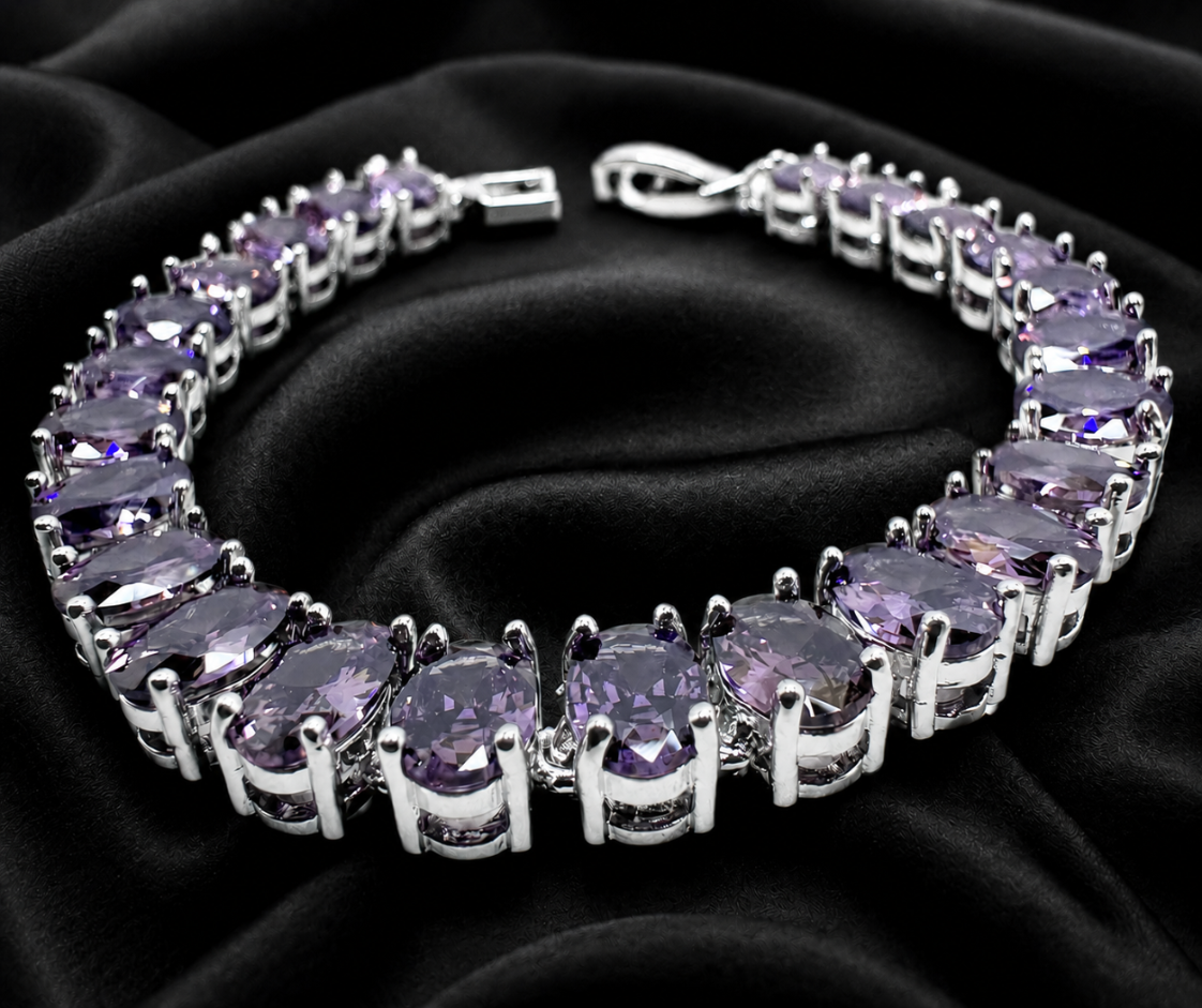 Silver bracelet with purple gemstones on a black satin background