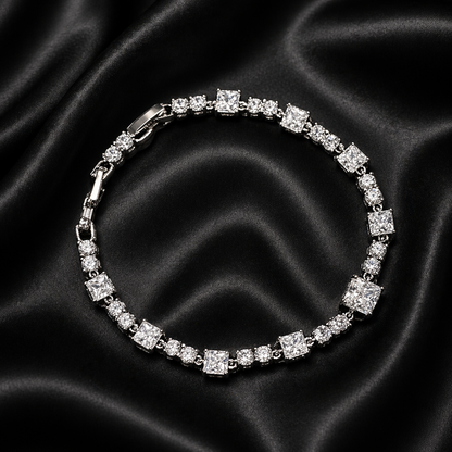 Silver bracelet with clear stones on a black satin background