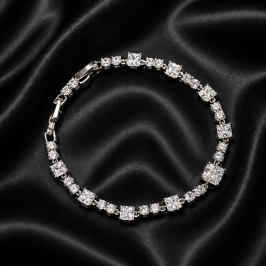 Silver bracelet with clear stones on a black satin background